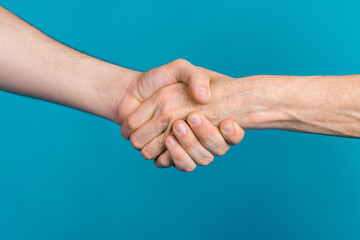 Photo of two mature young people arms palms shacking hands showing partnership isolated blue color background