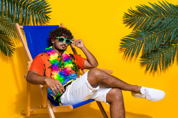 Photo of serious confident man wear print hawaii shirt fingers touch sunglass in summer weekend...