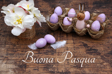 Biglietto d'auguri Buona Pasqua. Saluto pasquale con bouquet di fiori e uova di Pasqua su tavolo in...
