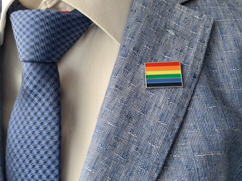 Man in Suit and Tie With Rainbow Pin