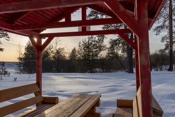 houses for outdoor recreation, winter landscape, sunny frosty day, wooden gazebo against the backdrop of a snowy landscape