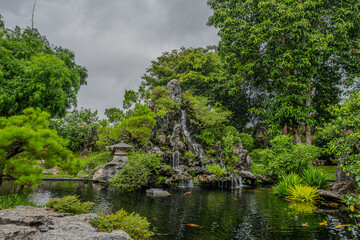 Fototapeta na wymiar Serene Waterfall Pond at Thien Mu Pagoda, Hue, Vietnam