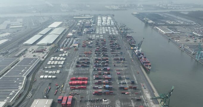 Aerial top down on container ship in the port of Antwerp, Belgium. Port full of containers rady for loading and unloading.
