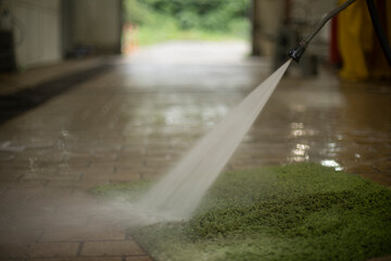 Wet Carpet. Carpet cleaning in the garage. Rinsing dirt from green cloth.