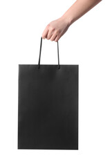 Woman holding paper shopping bag on white background, closeup