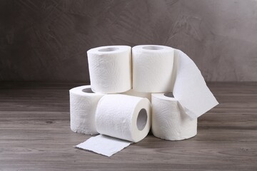 Soft toilet paper rolls on wooden table