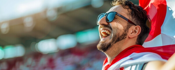 Happy Austrian male supporter with Austrian flag, Austrian male fan at a sports event such as...