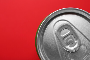 Energy drink in can on red background, top view. Space for text