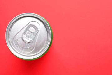 Energy drink in can on red background, top view. Space for text