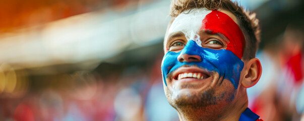 Happy Czech male supporter with face painted in Czech Republic flag, Czech male fan at a sports event such as football or rugby match, blurry stadium background, copy space - obrazy, fototapety, plakaty