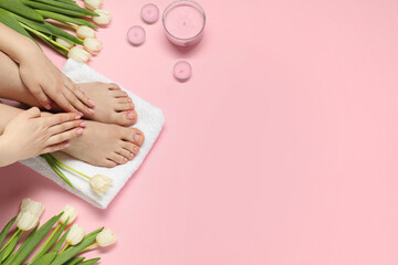 Closeup of woman with neat toenails after pedicure procedure on pink background, top view. Space...