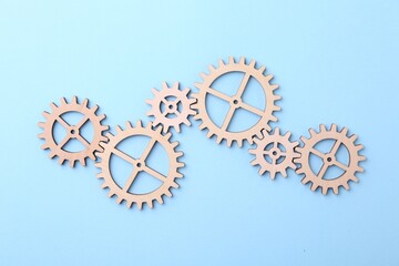 Fototapeta na wymiar Business process organization and optimization. Scheme with wooden figures on light blue background, top view