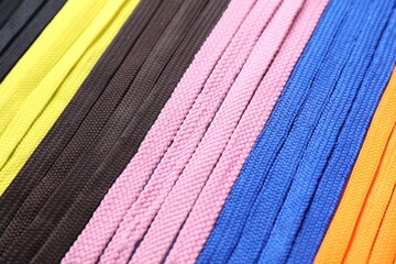 Many colorful shoe laces as background, closeup