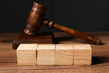 Law. Blank wooden cubes and gavel on table, closeup - obrazy, fototapety, plakaty