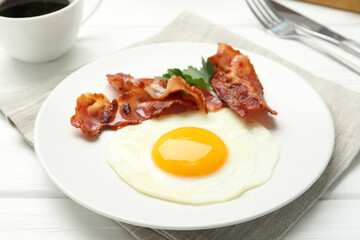 Delicious breakfast with sunny side up egg on white wooden table, closeup