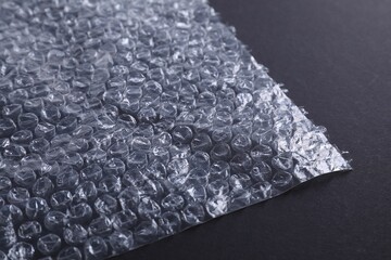 Transparent bubble wrap on black background, closeup