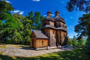 An old wooden church in Ukraine. Rural landscape with a church. Wooden Cossack Ukrainian church in the village of Zinkiv.