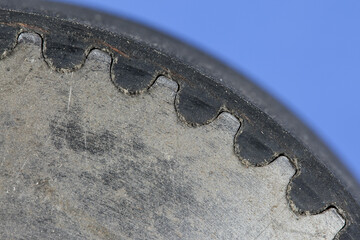 Close-up of a timing belt perfectly positioned on a timing belt pulley for smooth power...
