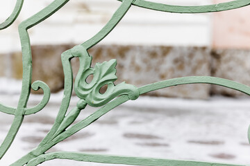 Vintage green forged railings details, close-up photo