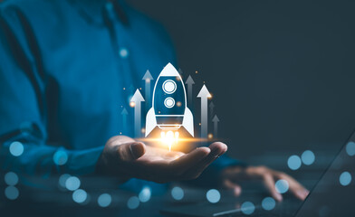 Business growth concept. Professional businessman projecting a holographic rocket symbolizing...