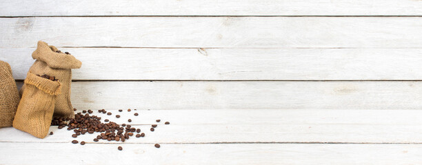 Sack with brown roasted coffee beans. Burlap sack. Scoop with grains. Banner.
