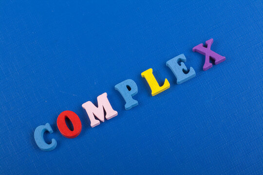 COMPLEX word on blue background composed from colorful abc alphabet block wooden letters, copy space for ad text. Learning english concept.