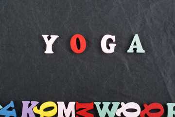 Yoga. composed from colorful abc alphabet block wooden letters.