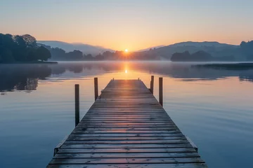 Cercles muraux Coucher de soleil sur la plage A beautiful sunrise over a calm lake, perfect for early morning exercise. Wooden dock extends into serene lake under the afterglow of a sunset