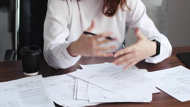 Cropped shot of hands of female financial advisor holding bills while helping clients with estimating expenses and planning budget