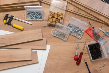 A scattered array of woodworking tools and materials on a wooden surface