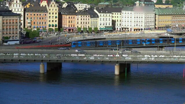 Multiple Trains Captured In Motion On A Bridge Over Stockholm'S Waterways, Depicting The City'S Active Public Transport System