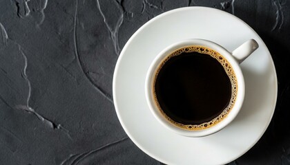 Obraz na płótnie Canvas cup of coffee on black background top view