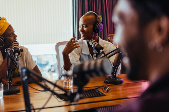 Engaging podcast recording session with smiling hosts in studio