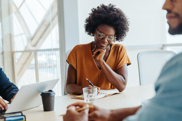 Business woman sitting in a collaborative brainstorming session in a professional office