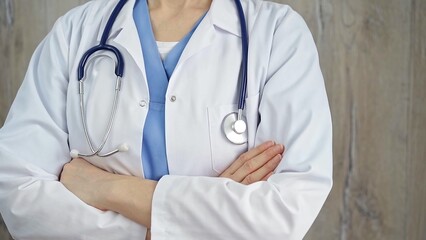 Confident healthcare professional with stethoscope. Close-up of a medical doctor in white coat with folded arms. Medicine concept