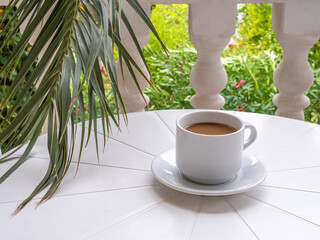cup of coffee on a white, round table
