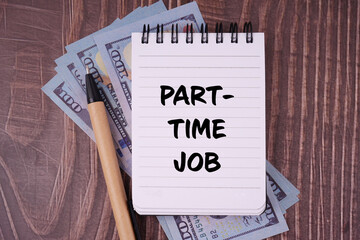 Job and financial management. PART TIME JOB written on a notepad. With blurred styled background.