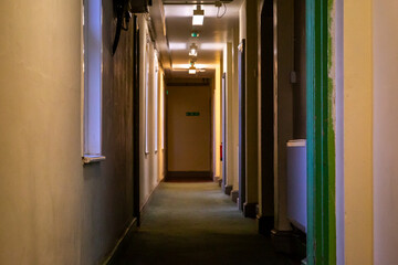 Corridor of a early 1900's building with modern updates to keep the building compliant and able to...