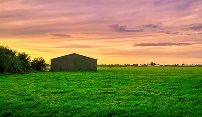 Foto auf Leinwand Farm shed in rural Holland at sunset. © Alex de Haas