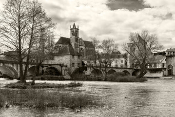 Scenic view of Moret-sur-Loing medieval and impressionist town in Ile-de-France listed among the Most Beautiful Detours of France, one hour from Paris. French travel background. Sepia historic photo