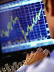 Stock trading investor, trader or broker analyst working analysing exchange market using computer investing money in financial market analyzing charts data looking at computer screen.