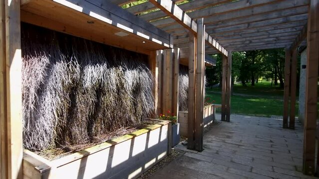 Brine graduation tower; pump of mineral waters, background of thorn branches. Spa park in Rabka