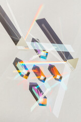 Glass geometric figures prisms with light diffraction of rainbow spectrum colors and complex...