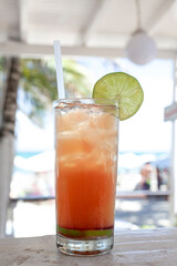 Beach Bliss: Enjoying a Tropical Drink with Fresh Lime Garnish