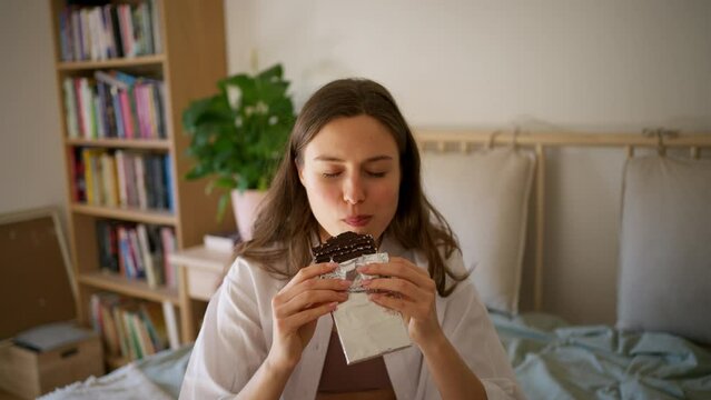 Enjoying chocolate. Woman has cravings for chocolate.