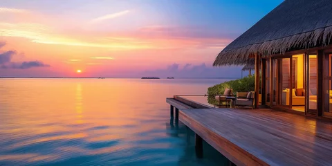 Fototapeten colorful sunset over the luxury ocean resort on tropical island © Anna