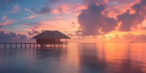 Fotobehang colorful sunset over the luxury ocean resort on tropical island © Anna