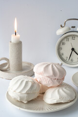 Fototapeta na wymiar Relaxation time. White delicate marshmallows and coffee on white background 