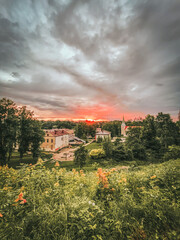 sunset after rain over city with dark dramatic clouds