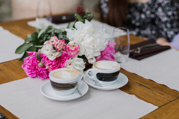 Two cups of cappuccino with elegant latte art, perfect for social meet-ups and coffee breaks